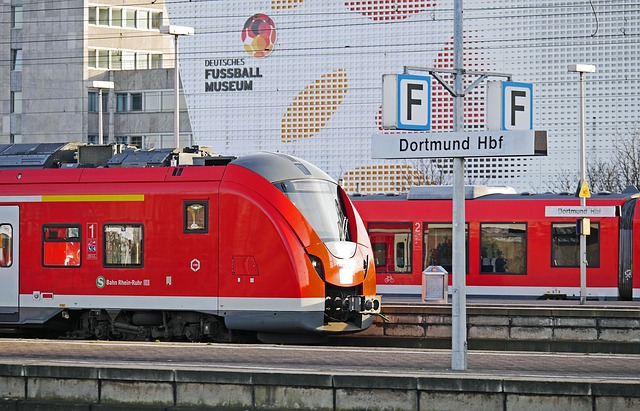 A red regional train at a platform at Dortmund main station.
