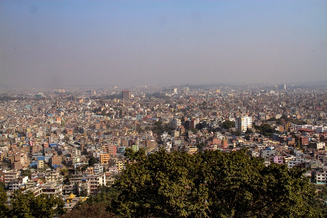 The Kathmandu valley from above, dense low-rise housing stretching to the hills.